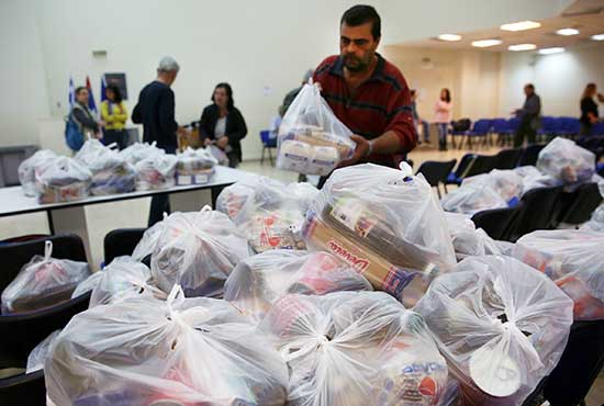 Bags of food and supplies are distributed to poor people in Athens, Greece, Nov. 9. CNS/Orestis Panagiotou, EPA