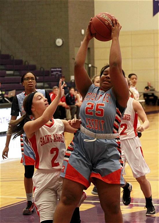 Cristo Rey Jesuit senior guard Ajaa Walker gets a rebound against St. Agnes junior guard Bailey Larkin Nov. 26. Photo courtesy Richard Graner
