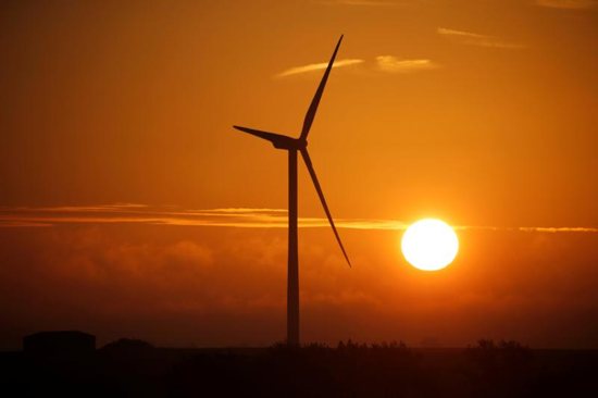 A power-generating windmill is pictured during sunrise in Escarmain, France