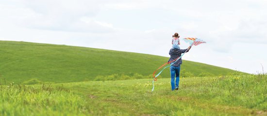 Father and son flying a kite
