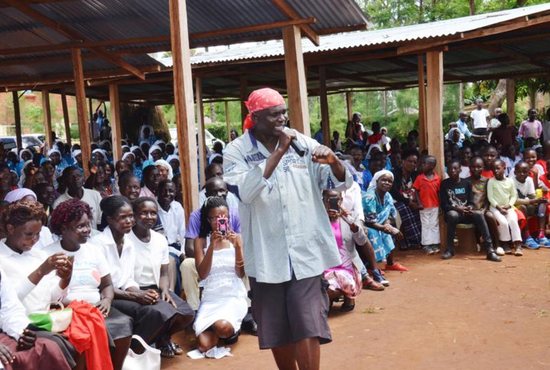Father Paul Ogalo performs rap songs about drug abuse, food insecurity, and the environment at St. Monica Church in Rapogi, Kenya