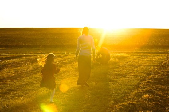 A family is seen on their family farm in St. Leo, Kan.