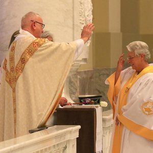 Father Edward Lamp blesses the Catholic Daughters' National Regent-Elect Sherry Nilles during her July 21 installation Mass at St. Joseph Cathedral in Sioux Falls, S.D.