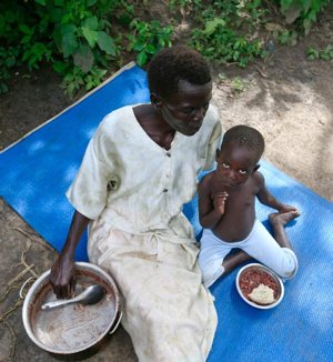 A refugee family from South Sudan eats a meal in 2017 at a settlement camp in Moyo, northern Uganda.