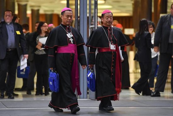 Chinese Bishops Joseph Guo Jincai of Chengde and Coadjutor Bishop John Baptist Yang Xiaoting of Yan'an depart the opening session of the Synod of Bishops on young people, the faith and vocational discernment