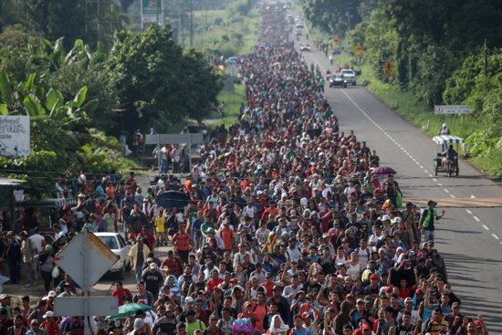 A large caravan of migrants from Central America, trying to reach the U.S., walk along a road Oct. 21 in Hidalgo, Mexico.