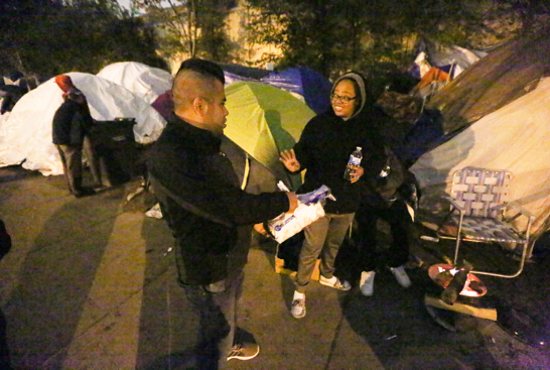 Oscar Luna of Holy Rosary in Minneapolis hands out food