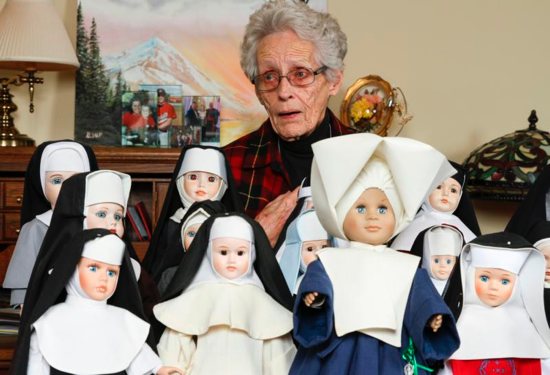 Margaret Alsup of Cumming, Ga., stands behind some of the 75 nun dolls Dec. 21, 2017, that she collected over the years. All of the dolls, which are clothed in authentic habits, have been donated to the Archdiocese of Atlanta's Office of Archives and Records. 
