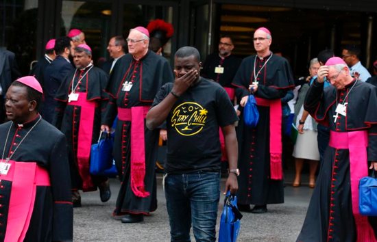 A youth delegate and bishops leave a session of the Synod of Bishops on young people, the faith and vocational discernment at the Vatican