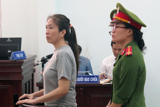 Vietnamese blogger Nguyen Ngoc Nhu Quynh, who is known as "Mother Mushroom," stands during her 2017 trial in Nha Trang. Vietnam has freed the well-known Catholic blogger and rights activist jailed two years ago for posting anti-government material on social media and forced her into exile in the United States.
