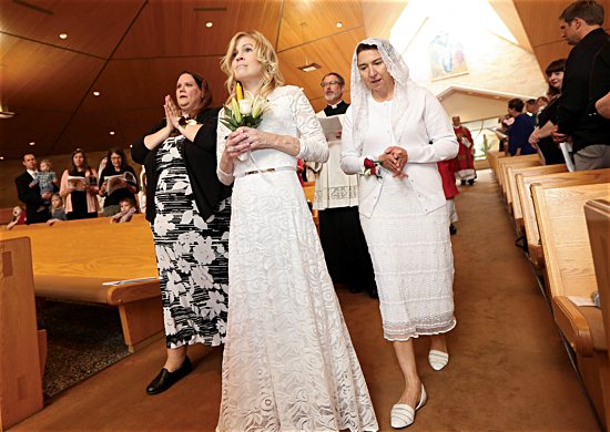 Jackie Hintze, center, leads the procession at the start of her consecration Mass Sept. 14 at St. Hubert in Chanhassen.
