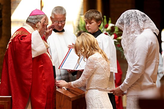 Archbishop Bernard Hebda prays a blessing over Jackie Hintze during her consecration Mass Sept. 14 at St. Hubert in Chanhassen.
