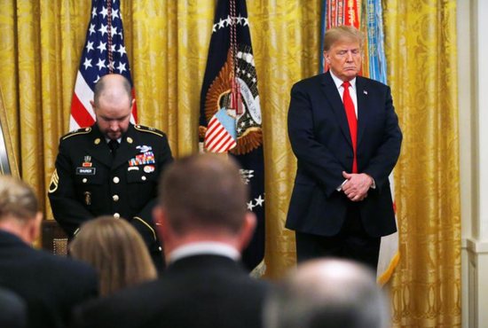U.S. President Donald Trump prays alongside former U.S. Army medic Ronald J. Shurer during a Medal of Honor ceremony Oct. 1 at the White House in Washington. Shurer, a parishioner at the Church of the Nativity in Burke, Va., was presented the Medal of Honor for actions he took while serving in 2008 in Afghanistan