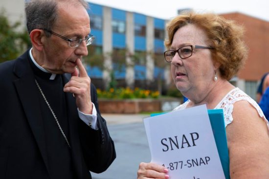 Judy Jones, Midwest regional leader of Survivors Network of those Abused by Priests, speaks with Bishop Lawrence T. Persico of Erie, Pa., shortly after her organization's Aug. 21 news conference in front of the headquarters of the Diocese of Erie. The Diocese of Erie announced it plans to launch a Survivors' Reparation Fund in February 2019.