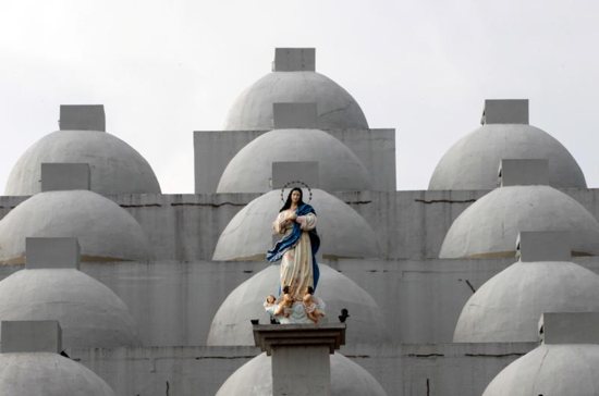 A statue of Mary is seen in 2017 atop the Cathedral of Managua in Nicaragua. A 24-year-old woman dumped sulfuric acid on a priest while he was hearing confessions in the cathedral Dec. 5.