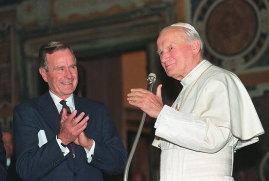 U.S. President George H.W. Bush applauds St. Pope John Paul II after a welcoming ceremony prior to their audience at the Vatican in 1991. Bush, the 41st president of the United States and the father of the 43rd, died Nov. 30 at his home in Houston. He was 94.