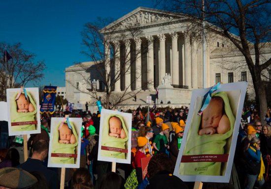Pro-life advocates gather near the U.S. Supreme Court in Washington Jan. 19, 2018. The novena "9 Days for Life" and related observances sponsored by the bishops' pro-life secretariat lead up to the annual Day of Prayer for the Legal Protection of Unborn Children Jan. 22, the anniversary of the Supreme Court's 1973 decisions in Roe v. Wade and Doe v. Bolton that legalized abortion.