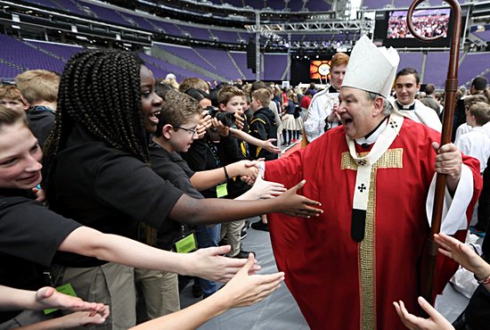 Archbishop Bernard Hebda greets Catholic elementary school students following the Mass of the Holy Spirit at U.S. Bank Stadium in Minneapolis