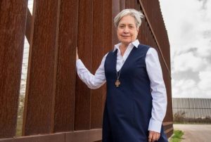Sister Norma Pimentel, a member of the Missionaries of Jesus, is pictured along a border wall in late February. She is the executive director of Catholic Charities of the Rio Grande Valley in the Diocese of Brownsville, Texas.