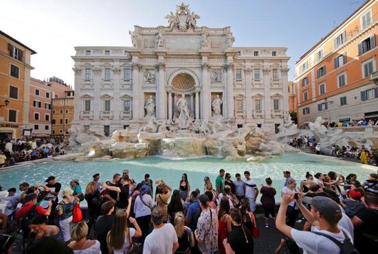 Tourists stand at Rome's Trevi Fountain Aug. 2, 2017.