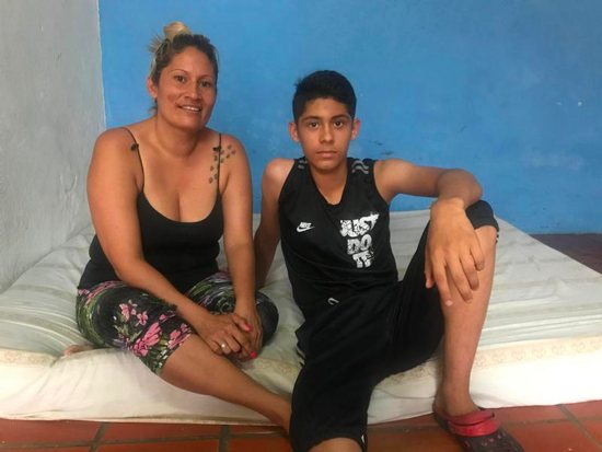 Venezuelan migrants Blanca Zambrano and her son Carlos, who arrived in Colombia in December, pose for a photo in Cucuta Feb. 9, 2019. The mother and son now live in a room with only a mattress. Zambano said she has struggled to get her son in school because she's been asked to pay enrollment fees of around $40 that she currently cannot afford.