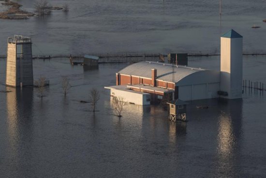 The flooded facility of the Camp Ashland Army National Guard in Ashland, Neb., is seen in this aerial photo March 17, 2019. Nebraska Gov. Pete Ricketts and the state's National Guard surveyed flooded farms, homes, bridges and highways, damage Ricketts called "devastating" and perhaps the worst in a half-century. At least three people have been reported killed. CNS photo/Herschel Talley, Nebraska National Guard handout via Reuters