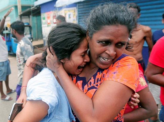 People in Colombo, Sri Lanka, react April 22, 2019, as military attend a suspected van containing explosives. Sri Lankan officials reported 290 confirmed deaths from the eight blasts at churches and hotels in three cities the previous day.