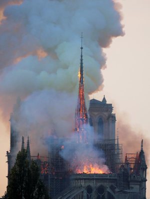 Flames and smoke billow from the Notre Dame Cathedral after a fire broke out in Paris April 15, 2019. Officials said the cause was not clear, but that the fire could be linked to renovation work.