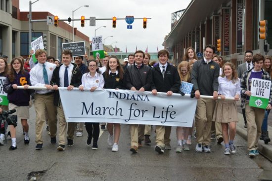 Students from St. Theodore Guerin High School in Noblesville, Ind., carry a banner during the Indiana March For Life
