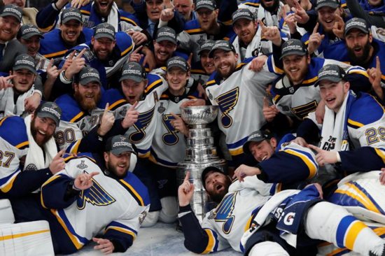 St. Louis Blues players pose for a team photo with the Stanley Cup after defeating the Boston Bruins in Game 7 of the 2019 Stanley Cup Final in Boston June 12, 2019. It was their first Stanley Cup in team history.