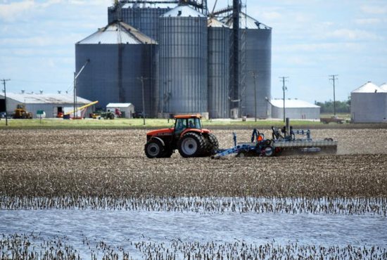 Standing water is seen near a tractor in Woodford County, Ill., June 13, 2019. 