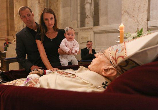 Jon and Maria O’Malley of St. Michael in Stillwater bring their infant daughter Mollie to the reviewal before Mass at the Cathedral of St. Paul.