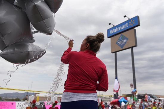 A woman releases balloons 