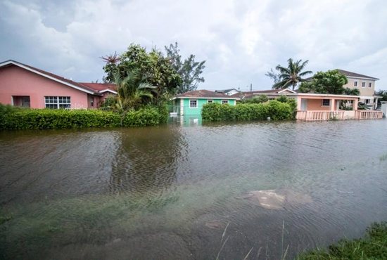 Houses line a flooded street in the aftermath of Hurricane Dorian in Nassau, Bahamas