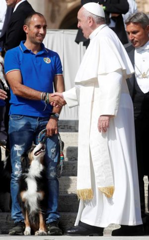 Pope Francis greets a member of an agility dog group