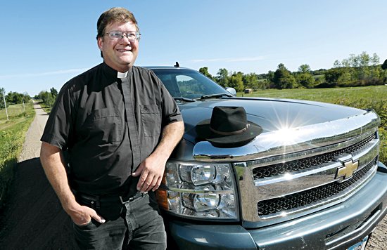 Father Gregory Mastey takes his pickup truck and his trademark hat wherever he goes on the rural roads
