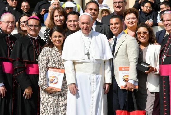 Pope Francis poses for a photo Sept. 18, 2019, with members of a U.S. delegation