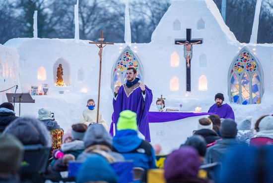 Father David Pellican, associate pastor at Divine Child Parish in Dearborn, Mich., preaches in a makeshift snow chapel Feb. 21, 2021, constructed by parishioners and students at the parish's elementary school and high school.