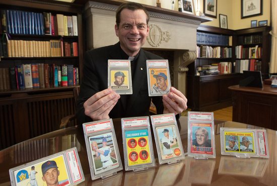 Father John Ubel shows baseball cards