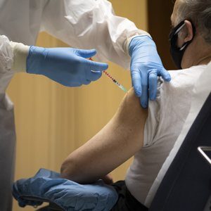 A man receives the first dose of the COVID-19 vaccine in the atrium of the Paul VI hall at the Vatican in this Jan. 20, 2021, file photo. A variety of sanctions have been issued by the head of the commission governing Vatican City State for citizens, residents and personnel who fail to follow current COVID-19 measures. The sanctions cover employees who refuse vaccination.