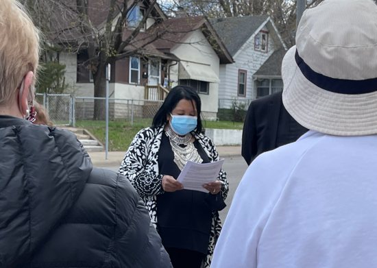 St. Bridget parishioner Bonnie Steele reads the names, ages and cause of death of three former neighbors who were violently killed as part of a “Come Together” walk April 17 through the parish’s north Minneapolis neighborhood. Father Paul Jarvis, associate pastor, and 11 others participated in the walk, which focused on praying for people in Minnesota and around the country who have lost their lives to violence.