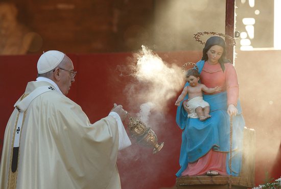 Pope Francis uses incense as he venerates a statue of Mary and the Christ Child during Mass at Verano cemetery in Rome in this Nov. 1, 2015, file photo. The pope has asked Catholics worldwide to pray the rosary every day throughout the month of May, pleading for an end to the pandemic and praying for those most affected by the disease and its consequences.
