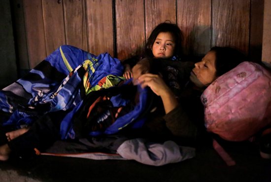 A migrant and her daughter are pictured in a file photo resting outside Our Lady of Guadalupe Cathedral in Ciudad Juárez, Mexico. Jesuit Refugee Service has started a program for migrants and asylum-seekers in Ciudad Juárez who have been languishing as they wait for an opportunity in the United States. 