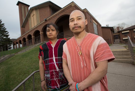 Pah Chi and his wife Yea Kler (Clare) stand in front of St. Patrick church in St. Paul.