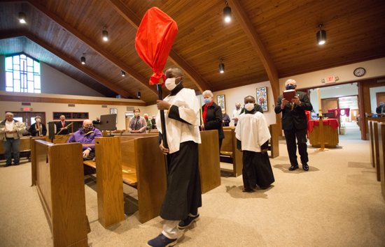 Jaden, left, and his brother Tyrick lead the procession at the start of Palm Sunday Mass March 28 at Blessed Sacrament in St. Paul.