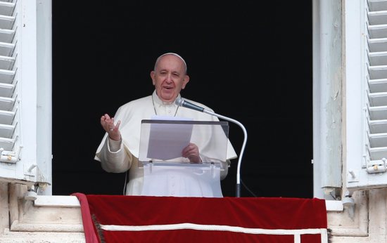 Pope Francis greets the crowd as he leads the "Regina Coeli" from the window of his studio overlooking St. Peter's Square at the Vatican April 18, 2021.