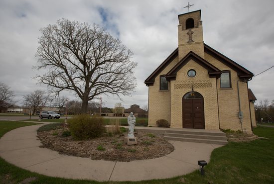 A statue of St. Joseph sits in front of the historic church that was built 124 years ago after a windstorm in 1985 destroyed the original church in what was then called Rice Lake. In the background is the new church, built in 1997, for the parish now called St. Joseph of the Lakes in Lino Lakes