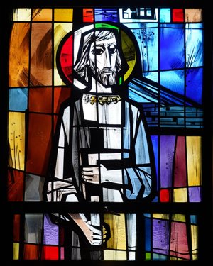 A depiction of St. Joseph holding a carpenter’s square is seen in a stained-glass window in the chapel of St. Joseph’s College in Patchogue, N.Y., in this 2020 photo. The feast of St. Joseph the Worker is May 1.