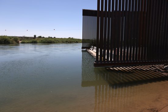 The Colorado River flows past the border wall in Andrade, Calif., April 19, 2021. The Biden administration canceled former President Donald Trump's border wall projects April 30 paid for with funds diverted from Defense Department accounts.