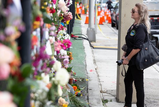 Tina Paul, vice mayor of Sunrise, Fla., visits a makeshift memorial June 26, 2021, for those who have died and who are still missing near the site of the partially collapsed condo building.